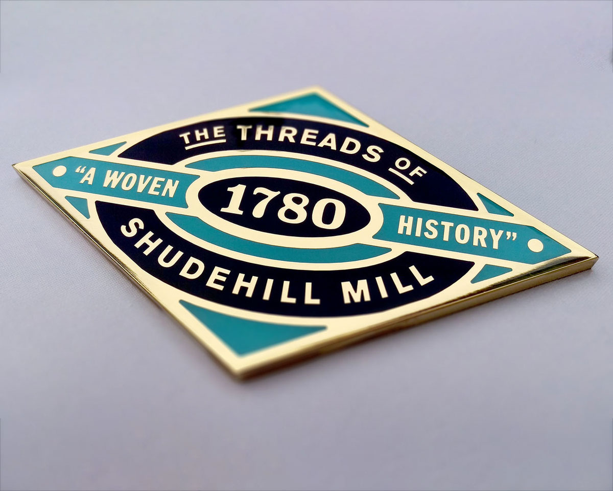 Brass and resin heritage way-marker/paving slab inlay.